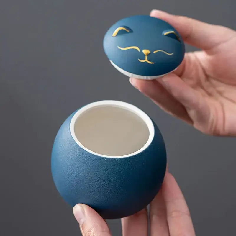 Blue ceramic cat-shaped lucky cat tea storage jar with gold accents for household tea and candy storage