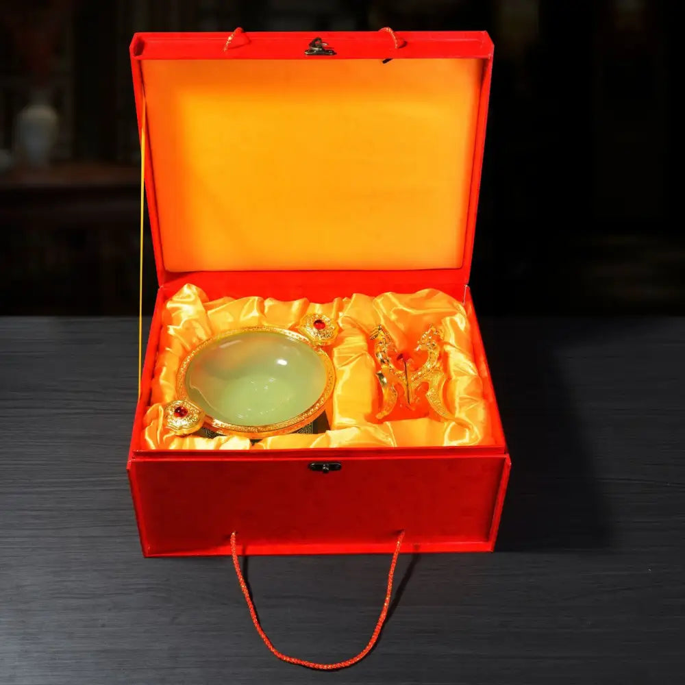 A jade-green oval decorbites lucky decoration flower stand with gold rim and handles in an orange satin gift box