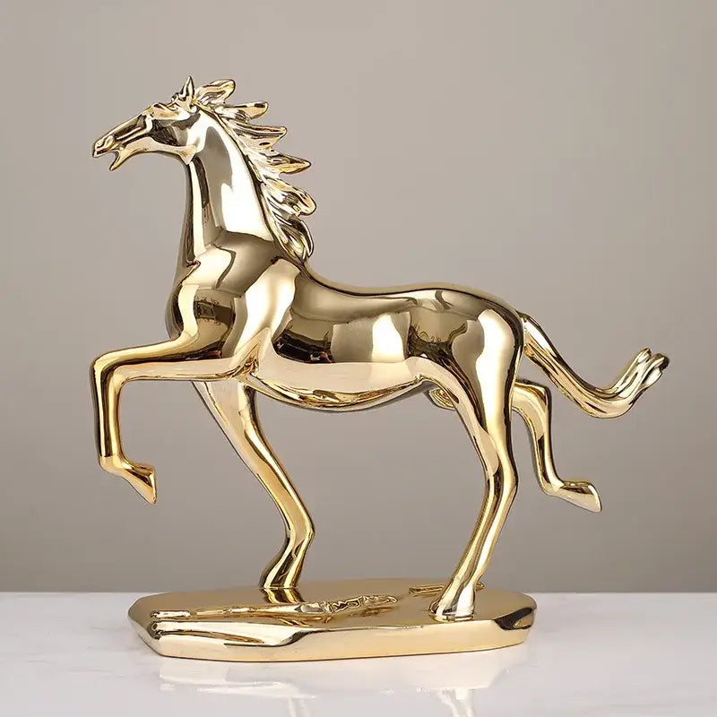 Golden metallic decorbites lucky horse resin figurine with sleek reflective surface in dynamic pose on matching base