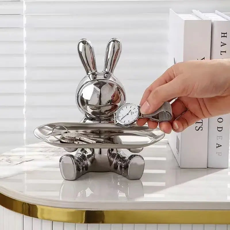 Shiny silver decorbites lucky rabbit key tray with reflective metallic finish holding keys and a watch for home organization