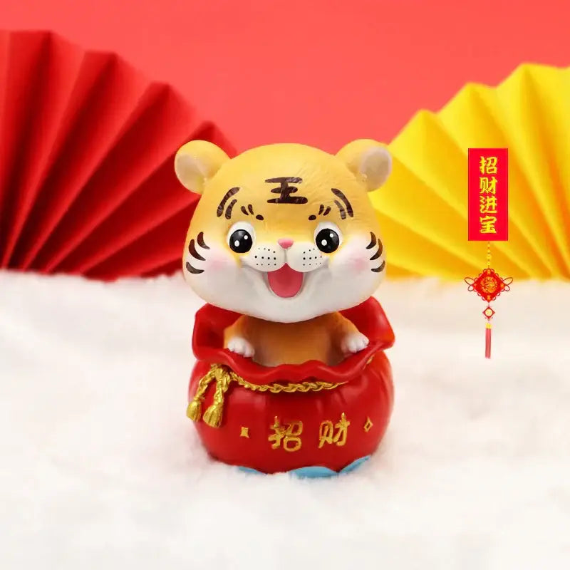 Decorbites™ lucky tiger figurine yellow with black stripes on red chinese money bag base featuring gold lettering