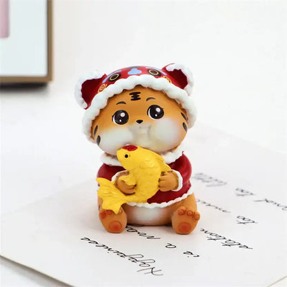 Cute orange tiger figurine wearing red and white santa hat holding yellow fish decorbites lucky tiger figurine