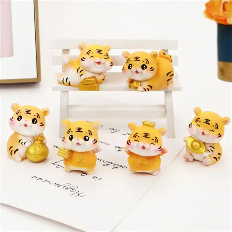Decorbites lucky tiger figurine with yellow and white colors holding a golden coin for new year fortune decor