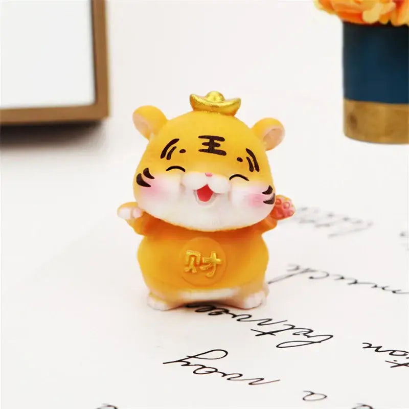 A cheerful yellow lucky tiger figurine with a gold crown and chinese characters for new year home decor