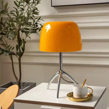 Vibrant orange glossy ceramic decorbites lumiere glass table lamp with sleek chrome tripod base for bedroom and living room