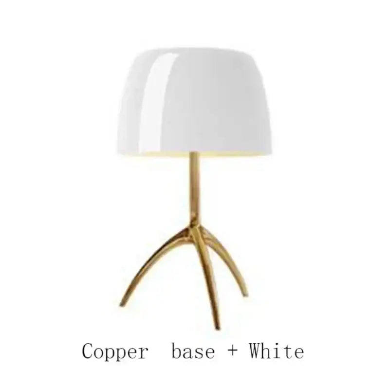 A sleek white lampshade on a polished copper tripod base for the decorbites lumiere glass table lamp