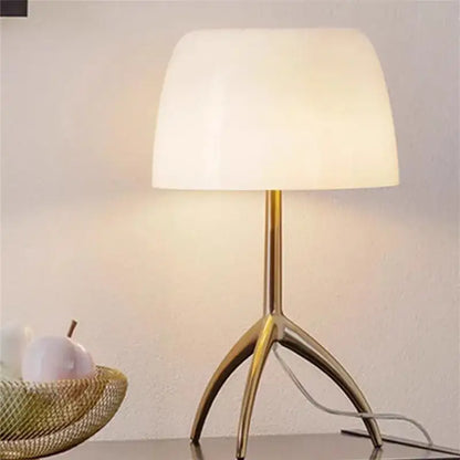 Gold-toned decorbites lumiere piccola chrome table lamp with soft off-white opal glass shade for bedside use