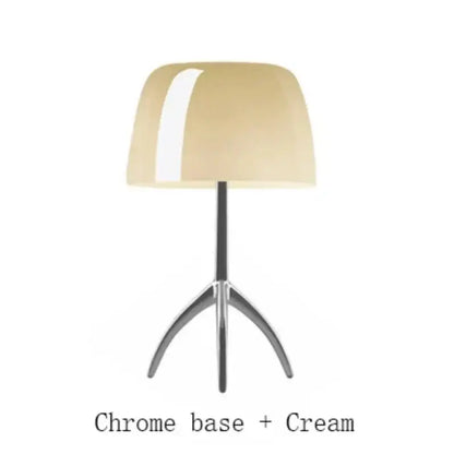 Cream-colored glossy lampshade on chrome tripod base in DecorBites Lumiere table lamp for bedroom living room use