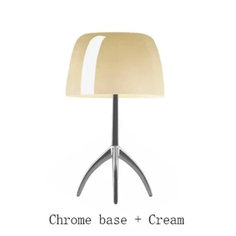 Cream-colored glossy lampshade on chrome tripod base in DecorBites Lumiere table lamp for bedroom living room use