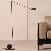 Black metal decorbites lumina floor lamp with slender articulated long arm and rectangular head for reading and study