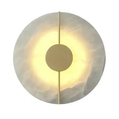 Modern circular decorbites lumind copper wall lamp with textured white stone face and polished brass accents emitting warm light