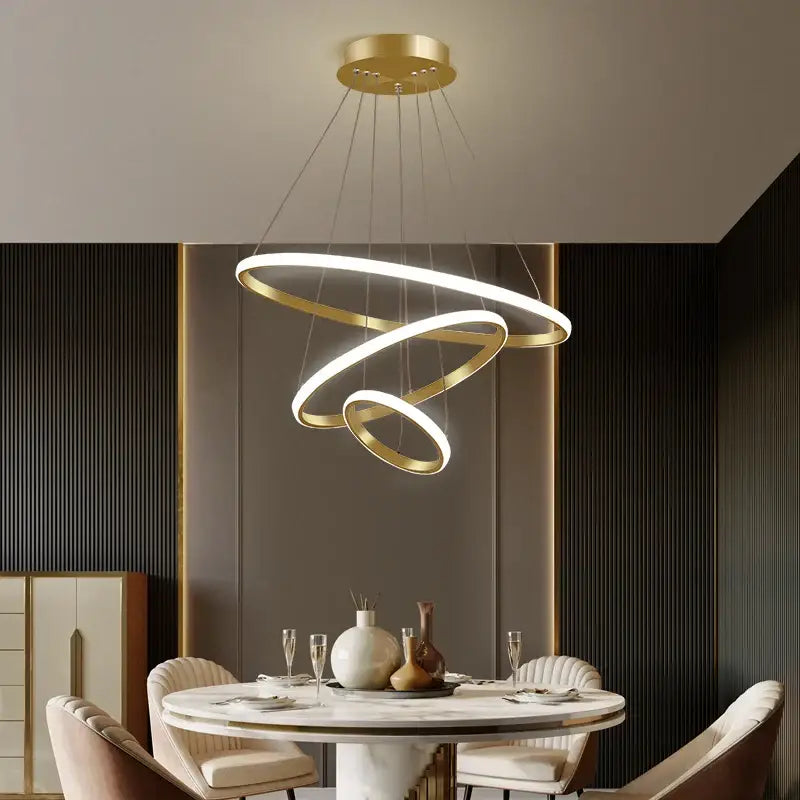 Gold-toned decorbites luminous circle pendant light with spiral led rings suspended from a circular mount