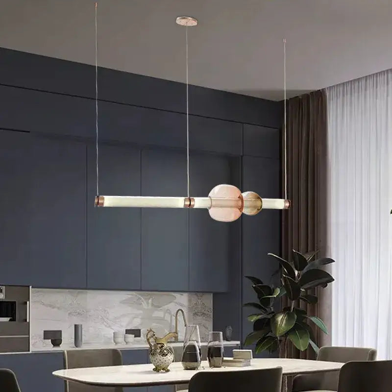 Modern luna glass tube chandelier with two translucent pink orbs and copper accents for kitchen dining or staircase lighting