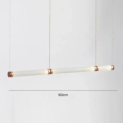 A sleek 102cm luna glass tube chandelier with frosted glass and copper-toned metal ends for kitchen or dining