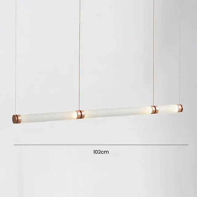A sleek 102cm luna glass tube chandelier with frosted glass and copper-toned metal ends for kitchen or dining