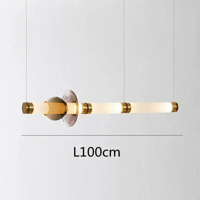 Modern minimalist luna glass tube chandelier with frosted glass tubes and warm brass accents for kitchen and dining areas