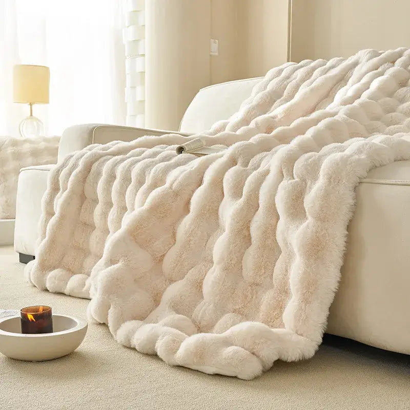 Cream-colored plush faux rabbit fur throw blanket with chunky twisted knit texture decorbites luxe faux for cozy use