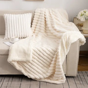 Cream-colored decorbites luxe double-layer blanket with faux-rabbit fur and ribbed textured plush surface for cozy warmth