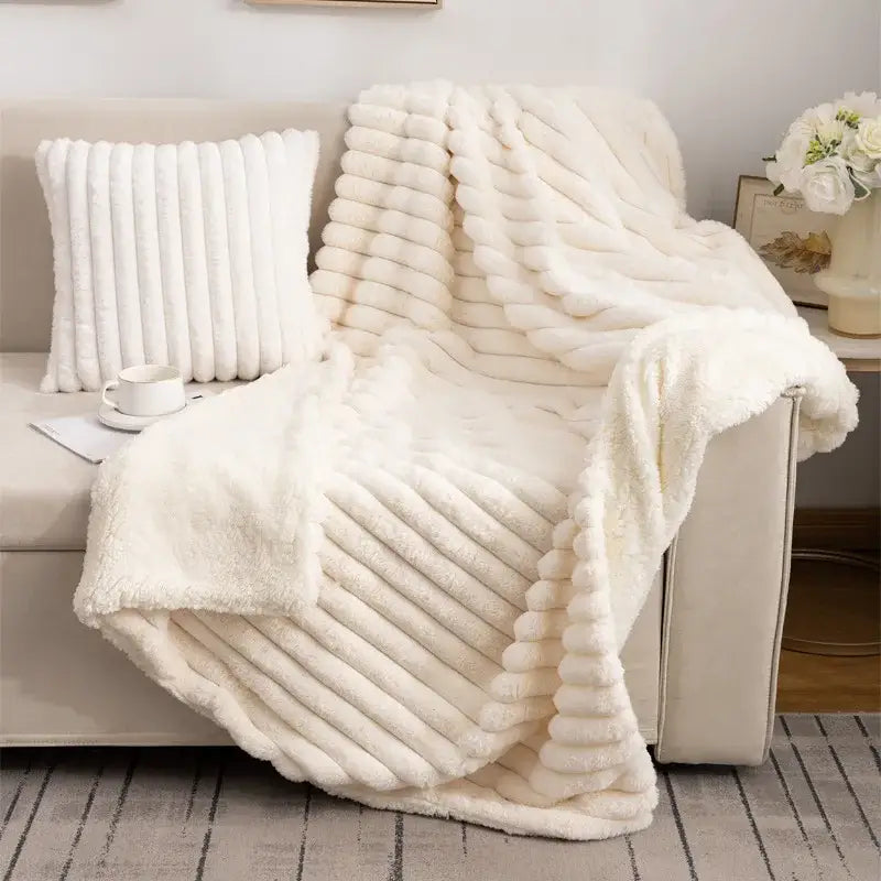 Cream-colored decorbites luxe double-layer blanket with faux-rabbit fur and ribbed textured plush surface for cozy warmth