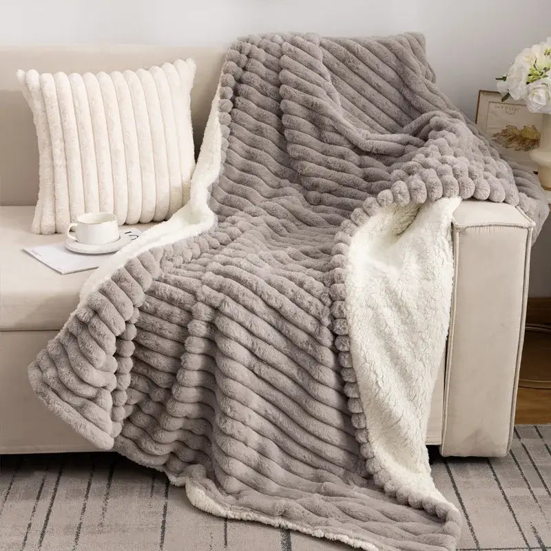 A cozy gray plush decorbites luxe double-layer blanket with ribbed texture and soft white faux-rabbit fur lining