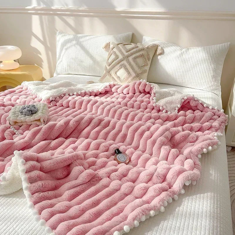Pink fluffy weighted blanket with pom-poms and floral pattern made from luxe faux rabbit wool for cozy warmth