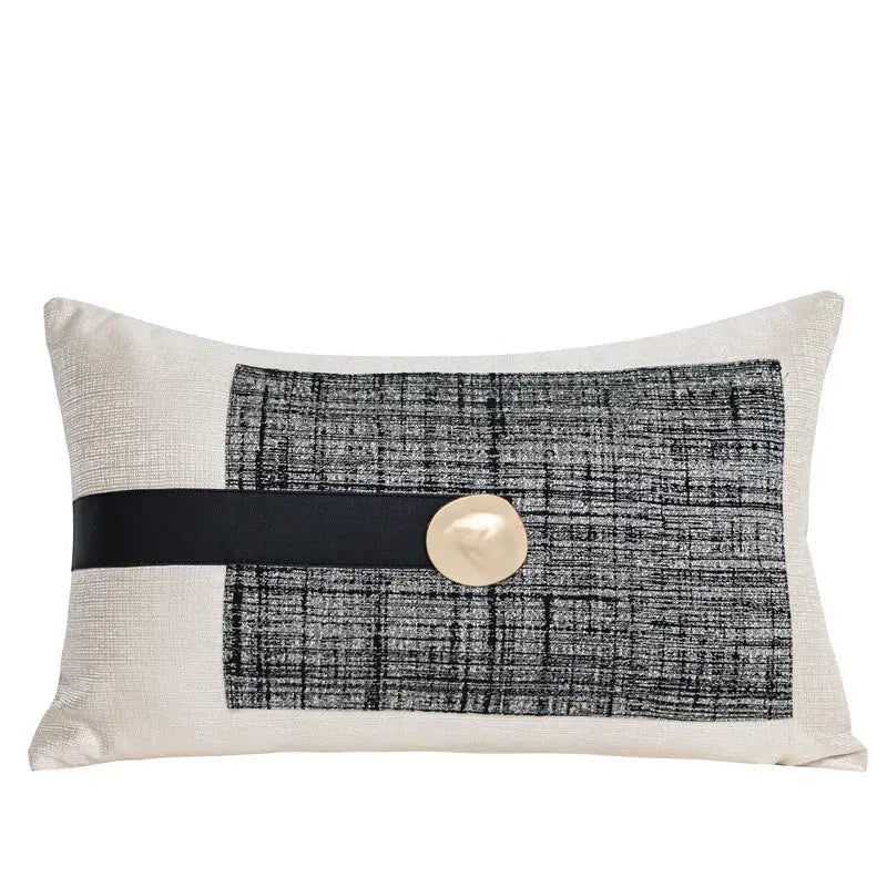 Rectangular throw pillow with textured black and white pattern, wide black ribbon, and off-white button in decorbites luxe flannelette leather cushion covers