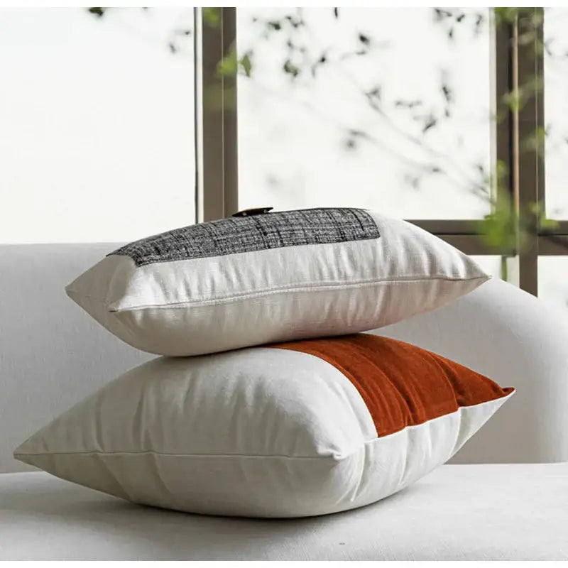 Two rectangular cushion covers from decorbites luxe flannelette featuring orange velvet and gray plaid leather patchwork designs