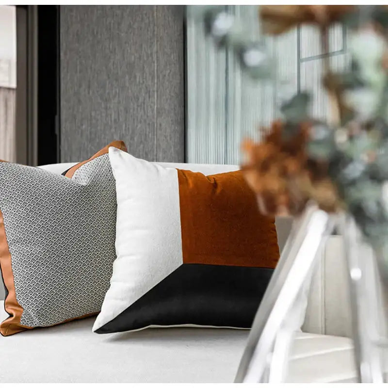 Modern geometric throw pillow with bold white burnt orange and black panels in decorbites luxe flannelette leather cushion covers