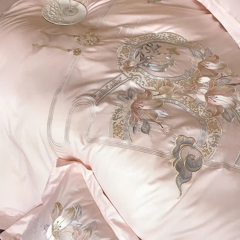 Pink satin bedding set with intricate gold and silver floral embroidery from decorbites luxe floral bird collection
