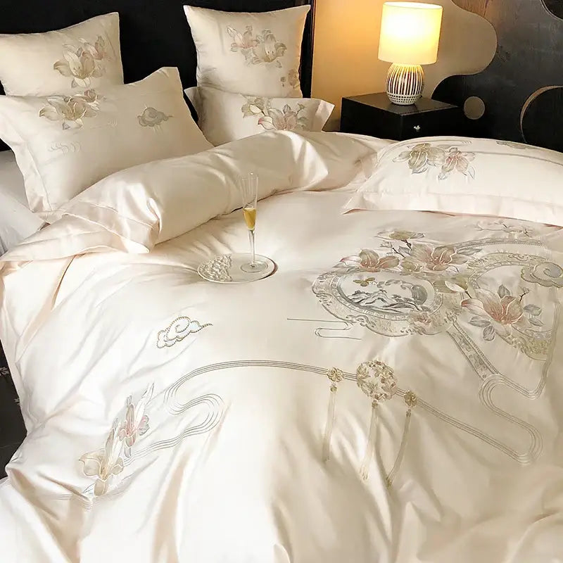 Cream-colored creambites luxe floral bedding set with intricate gold and silver floral and cloud embroidery in satin