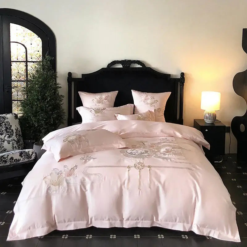Pink satin bedding set with delicate floral embroidery and central motif from decorbites luxe floral bird collection