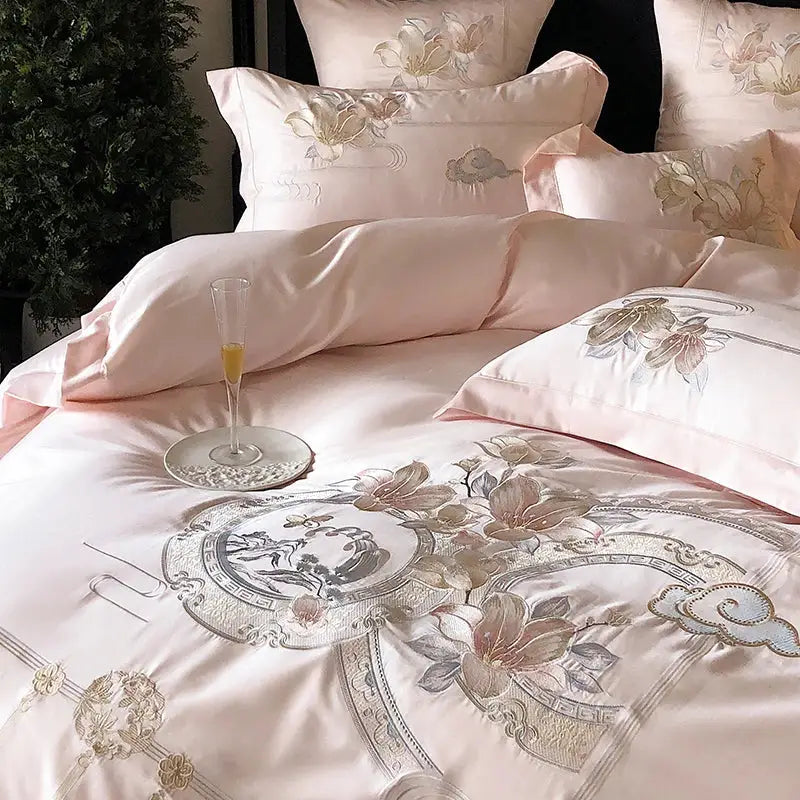 Pink satin bedding set with intricate gold and silver floral embroidery from decorbites luxe floral bird collection