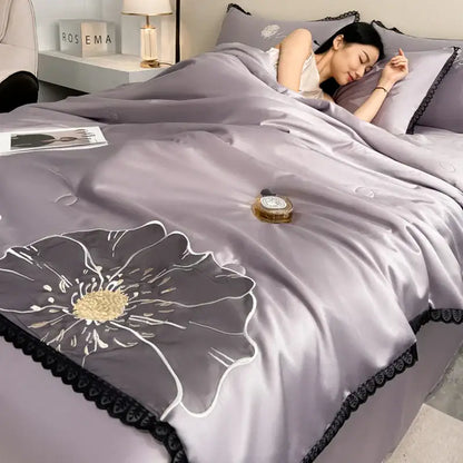 DecorBites luxe flower embroidered quilt set with lavender satin, gold center floral design, and black lace trim