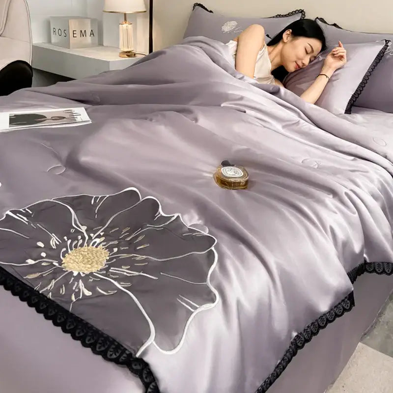 DecorBites luxe flower embroidered quilt set with lavender satin, gold center floral design, and black lace trim