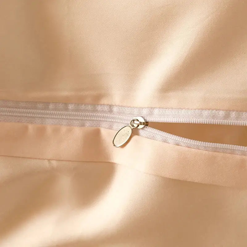 A delicate beige satin zipper with a silver metal pull tab on decorbites luxe flowers egyptian cotton bedding set