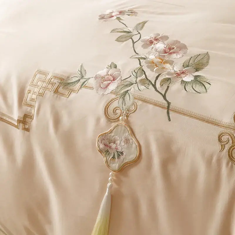 Beige satin pillowcase with pink white floral embroidery and gold geometric border in decorbites luxe flowers egyptian cotton bedding set
