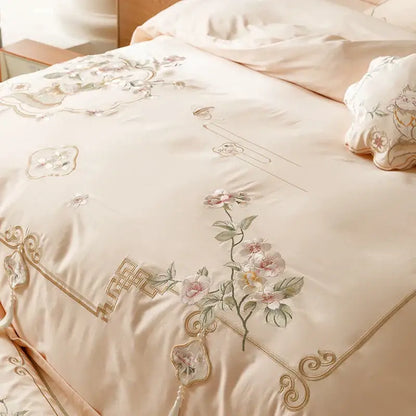 Cream-colored satin duvet cover with pink gold floral embroidery and chinese border in decorbites luxe flowers egyptian cotton bedding set