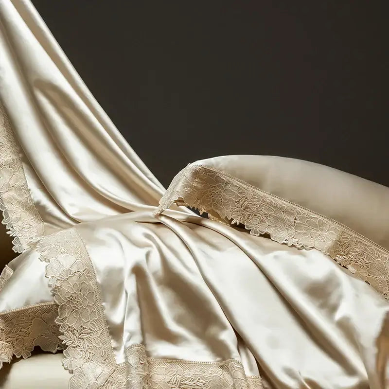 Cream-colored satin pillowcase with delicate floral lace trim from DecorBites Luxe French lace bedding set