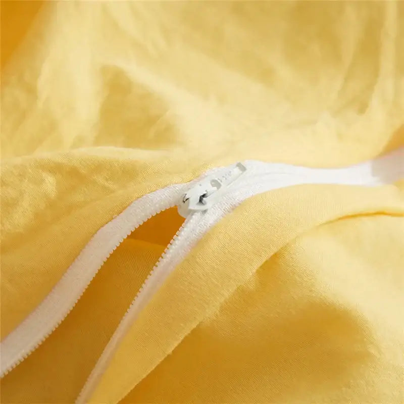 Soft yellow fabric with white zipper closure of decorbites luxe furball tasseled queen king size bedding set