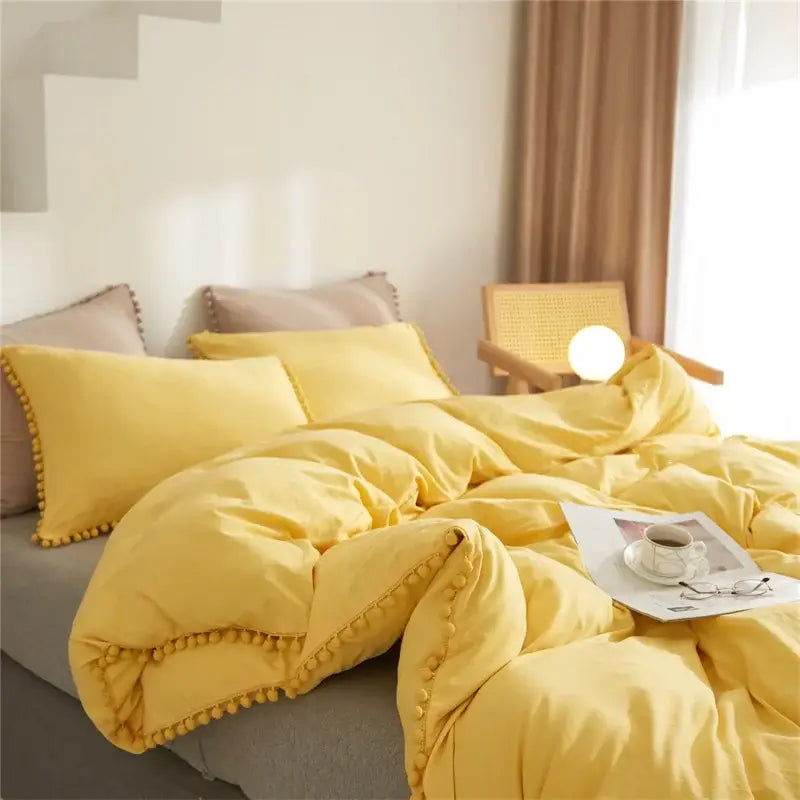 Yellow pom-pom trim bedding set from decorbites luxe furball tasseled collection queen king size duvet cover