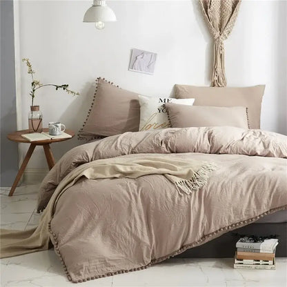 Beige duvet set with soft textured fabric and decorative pom-pom trim from the decorbites luxe furball tasseled bedding set