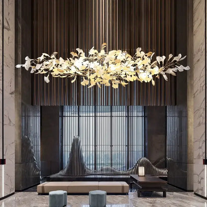 A gold-toned decorbites luxe ginkgo pendant light with leaf-shaped elements on a dark wooden slat wall background