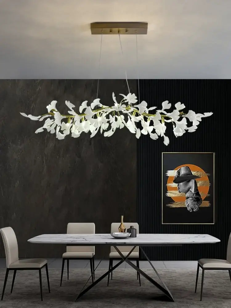 White orchid-shaped pendant light with gold-toned ceiling mount in decorbites luxe ginkgo leaves chandelier pendant light