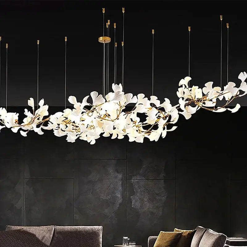 Elegant white porcelain pendant light with gold-toned branches and slender rods decorbites luxe ginkgo leaves chandelier