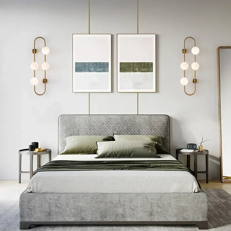 Gray upholstered bed with diamond patterned headboard and footboard showcased alongside decorbites luxe glass ball led wall sconce
