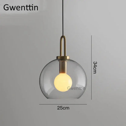 Decorbites luxe glass ball pendant light with clear glass globe brass accents and warm glowing bulb for home decor