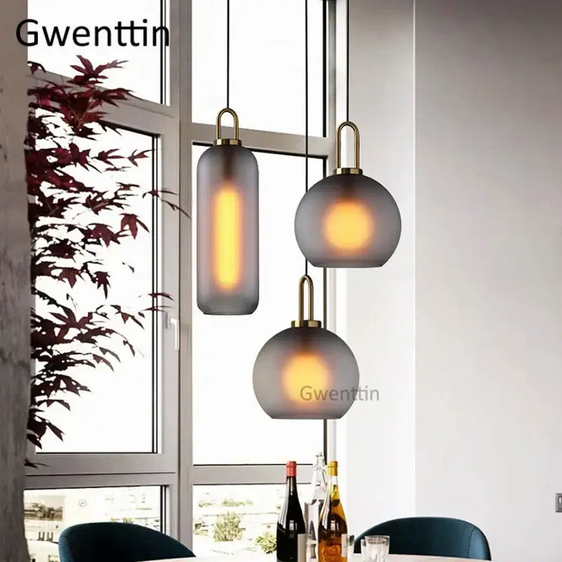 Set of three decorbites luxe glass ball pendant lights with frosted gray glass and brass accents for home decor