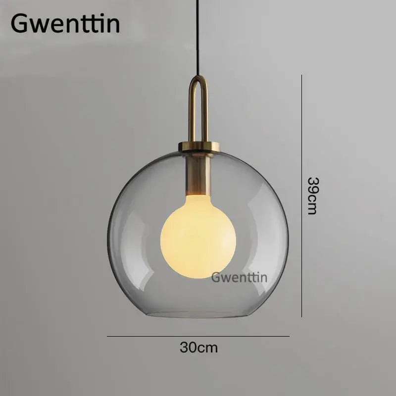 A modern decorbites luxe glass pendant light with clear glass ball and brass-toned metal fixture for home decor