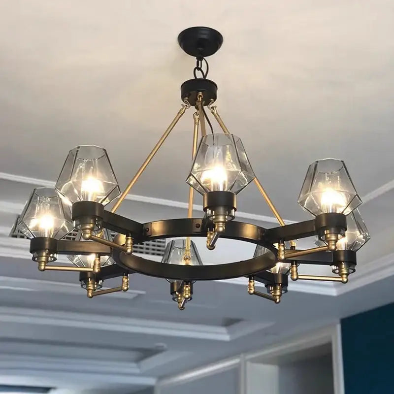 A modern decorbites luxe glass chandelier with a dark bronze frame and clear faceted glass shades for living rooms
