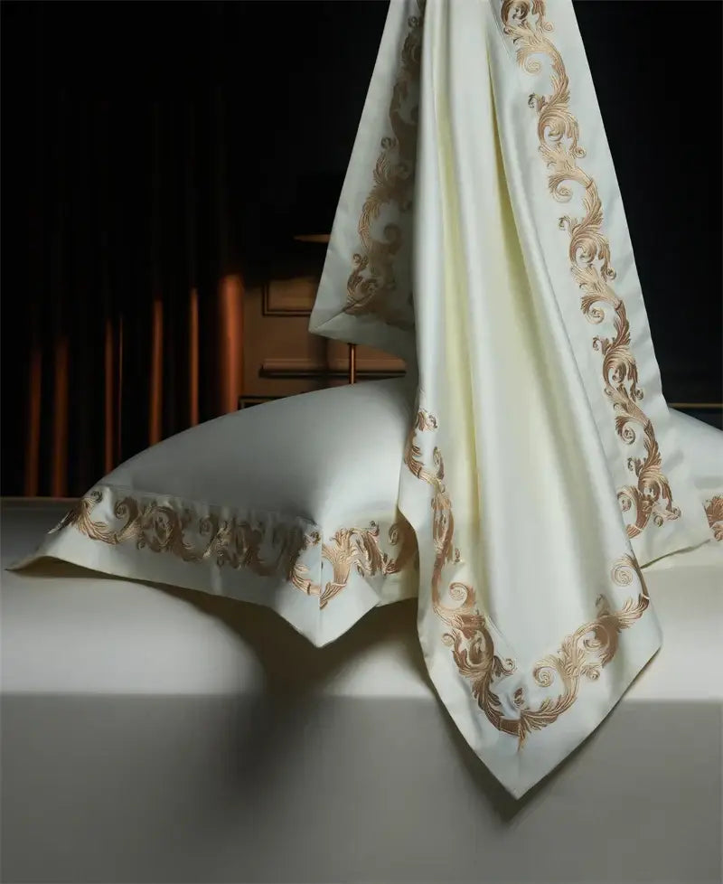 Cream-colored satin pillowcase with intricate luxe gold embroidery from decorbites luxe gold bedding set